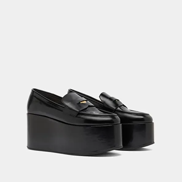 Platform loafers in black glazed leather