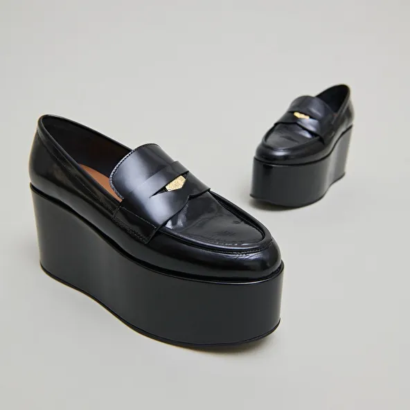 Platform loafers in black glazed leather