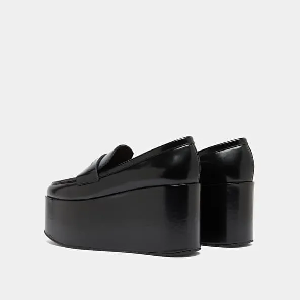 Platform loafers in black glazed leather